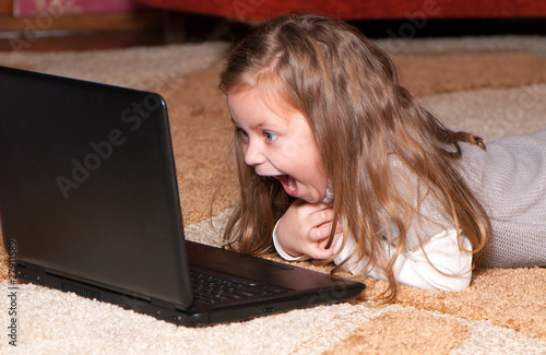 Photo: Portrait of a little girl with a laptop Portrait of a little girl with a laptop
