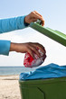 throwing away garbage at the beach