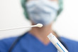 masked nurse asservating an assay