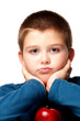 Young boy deciding to eat a healthy apple