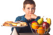 boy thinking over a healthy snack or a dessert