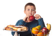 boy choosing a healthy apple snack over a dessert