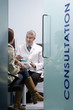 Pharmacist consulting with customer about medication