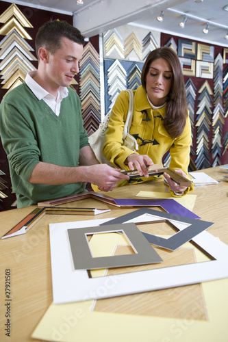 Photo: Salesman helping customer in frame shop Salesman helping customer in frame shop