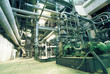 Equipment, cables and piping as found inside of a modern industr