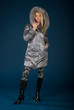 Beautiful girl standing at studio in jacket and jackboot Beautiful girl standing at studio in jacket and jackboot