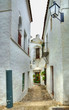 Small narrow street in spanish city with white houses Small narrow street in spanish city with white houses