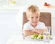 Portrait of a little boy eating a healthy salad for lunch
