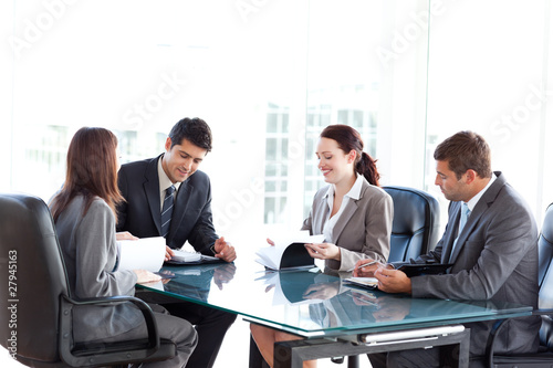 Photo: Four business people during a meeting Four business people during a meeting