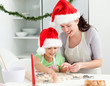 Lovely mother and daughter preparing Christmas cookies