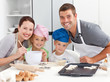 Portrait of a joyful family cooking littles cakes Portrait of a joyful family cooking littles cakes
