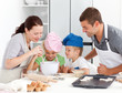 Photo: Adorable family baking together in the kitchen Adorable family baking together in the kitchen