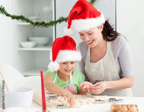 Photo: Lovely mother and daughter preparing Christmas cookies Lovely mother and daughter preparing Christmas cookies