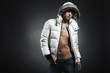 Fashion portrait of the young beautiful man in a white jacke