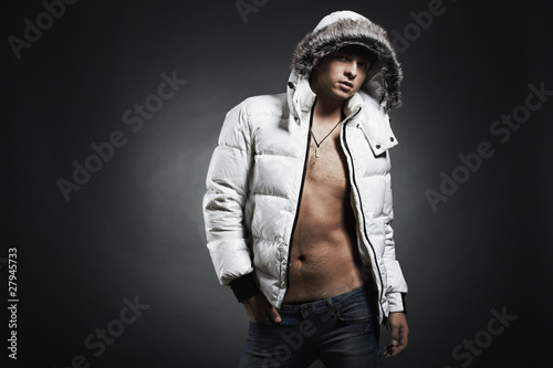Photo: Fashion portrait of the young beautiful man in a white jacke Fashion portrait of the young beautiful man in a white jacke