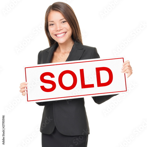 Photo: Realtor / Real estate agent woman sold sign on white background Realtor / Real estate agent woman sold sign on white background