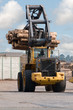 Skidder hauling logs at sawmill. Skidder hauling logs at sawmill.