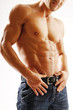 An attractive strong man posing in jeans