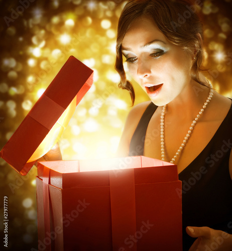 Photo: Beautiful Girl Getting Christmas or New Year Gift Beautiful Girl Getting Christmas or New Year Gift
