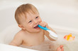 Cute baby boy playing in a tub