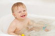 Cute baby-boy sitting in a bath tub