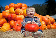 Cute baby-boy holding a pumpkin