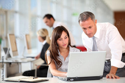 Photo: Manager and secretary working in the office Manager and secretary working in the office