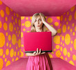 blonde in pink dress with laptop