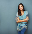 Confident brunette standing against the wall Confident brunette standing against the wall