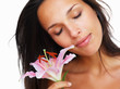 Brunette with eyes closed holding stargazer lily Brunette with eyes closed holding stargazer lily