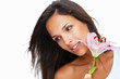 Brunette holding stargazer lily and while looking away Brunette holding stargazer lily and while looking away
