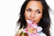 Brunette holding stargazer lily towards camera Brunette holding stargazer lily towards camera