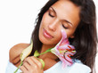 Brunette brushing stargazer lily against cheek Brunette brushing stargazer lily against cheek