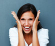 Woman laughing with hands against cheeks