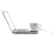 Cappuccino cup with spoon on laptop Cappuccino cup with spoon on laptop