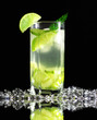 Photo: Mojito cocktail with fresh limes on a black background Mojito cocktail with fresh limes on a black background