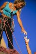 Climber reaching for a helping-hand.