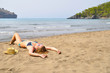 sexy woman is lying on the wild beach