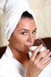 woman in towel drinking water