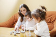 Mummy playing with daughters at home