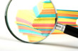 magnifying glass and a stack of paper