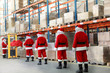 santa clauses  in the line for the sacks of gifts in storehouse