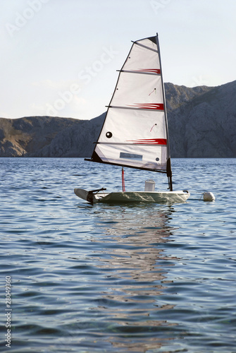 Photo: lonely sailboat in the adriatic sea lagoon lonely sailboat in the adriatic sea lagoon