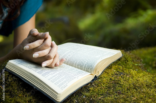Photo: Young woman reading bible Young woman reading bible