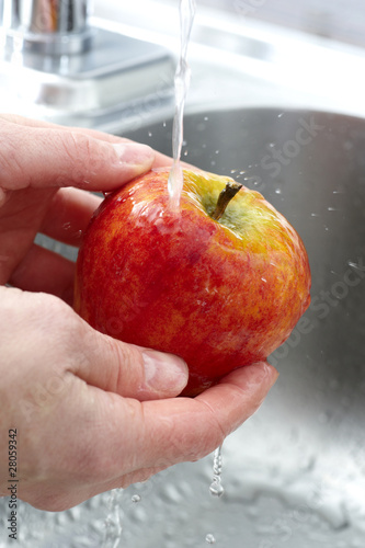 Photo: Washing an apple - close up Washing an apple - close up