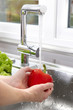 Washing an organic red pepper