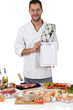 Young attractive chef caucasian male , menu