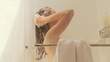 Woman washing hair in shower