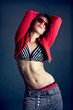 Modern hip-hop dancer posing on studio background.