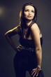 Beautiful brunette woman posing on dark background. Beautiful brunette woman posing on dark background.